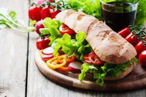 Vegan sandwich with salad, tomato and radish